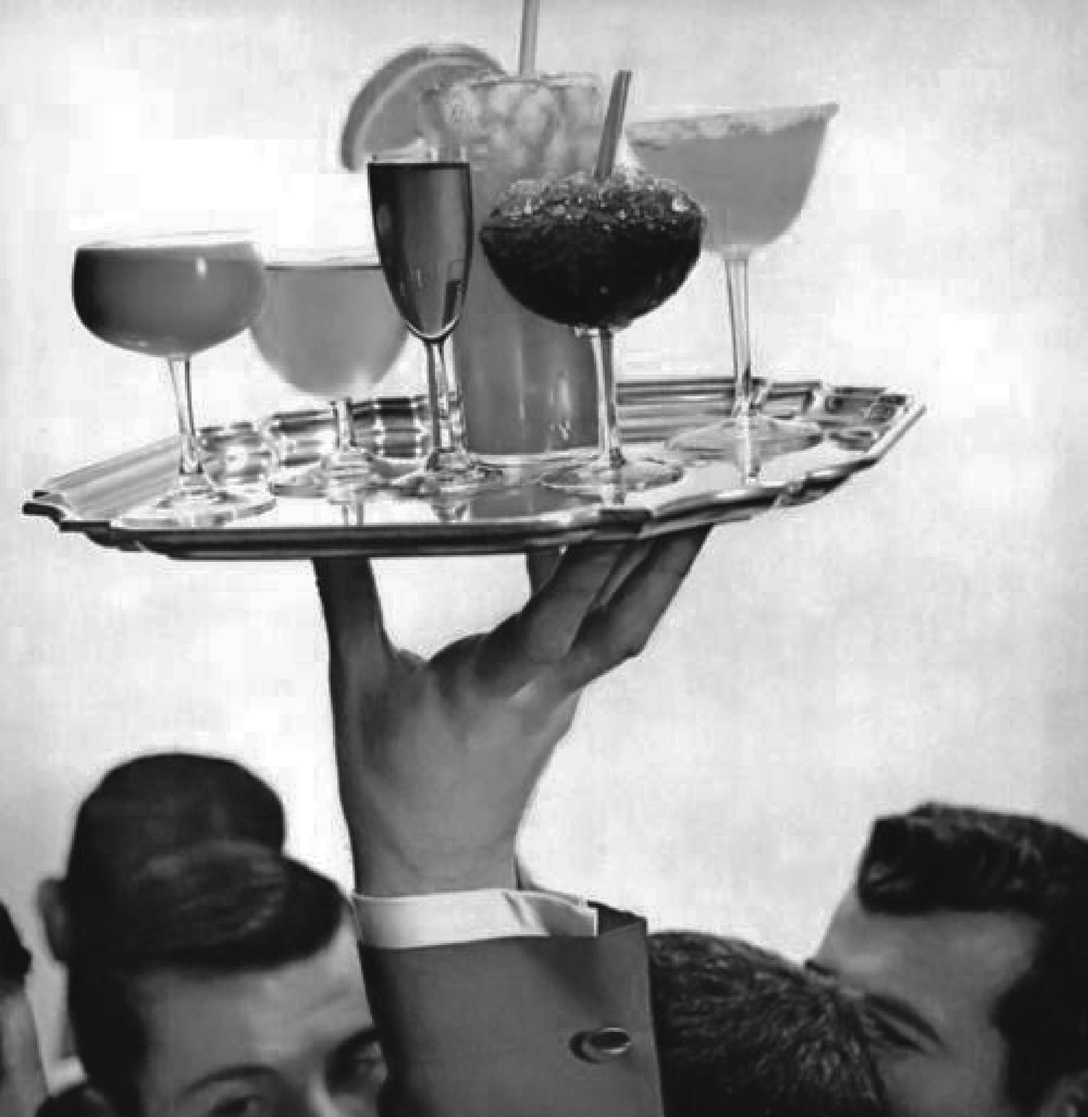 a man holding a tray with drinks on it