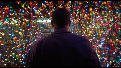 a man standing in front of a wall of lights