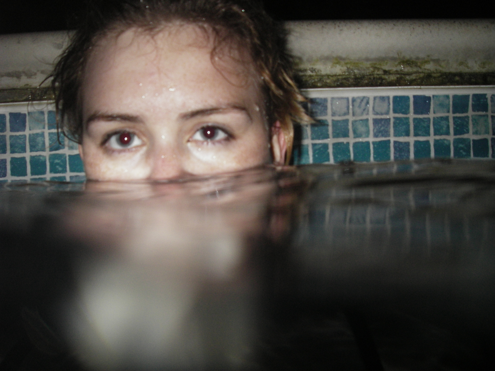 a woman is submerged in a pool of water