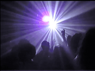 a group of people standing in front of a purple light