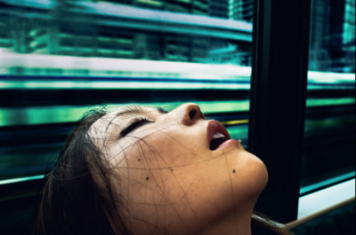 a woman looking up at a train passing by