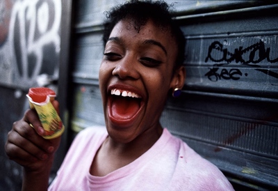 a young girl holding a can of food and laughing