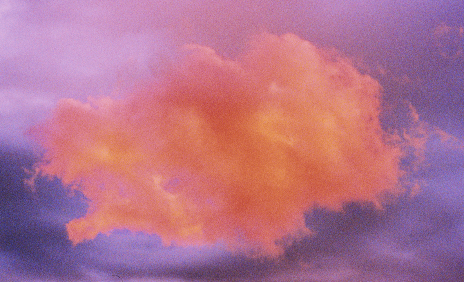 a plane is flying through a cloudy sky