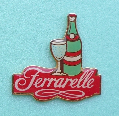 a pin with a bottle and a glass on it