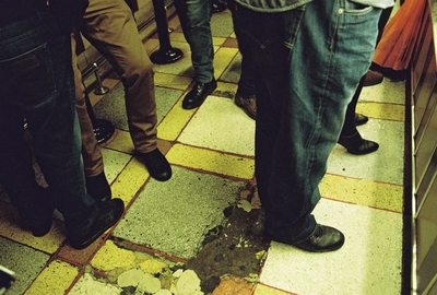 a group of people standing on a tiled floor