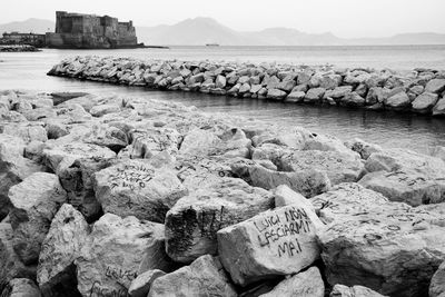 a black and white photo of some rocks and water