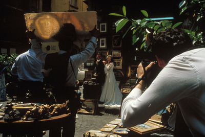 a man taking a picture of a woman in a wedding dress