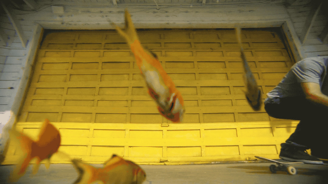 a man riding a skateboard next to a yellow wall