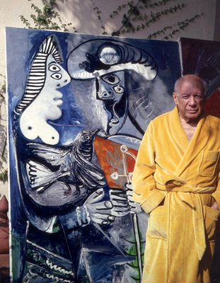 a man in a robe standing next to a painting