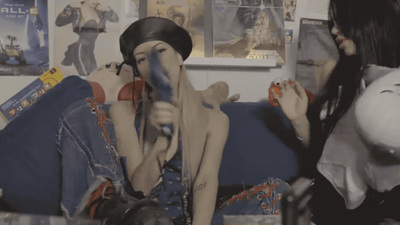 a couple of women sitting on top of a blue couch