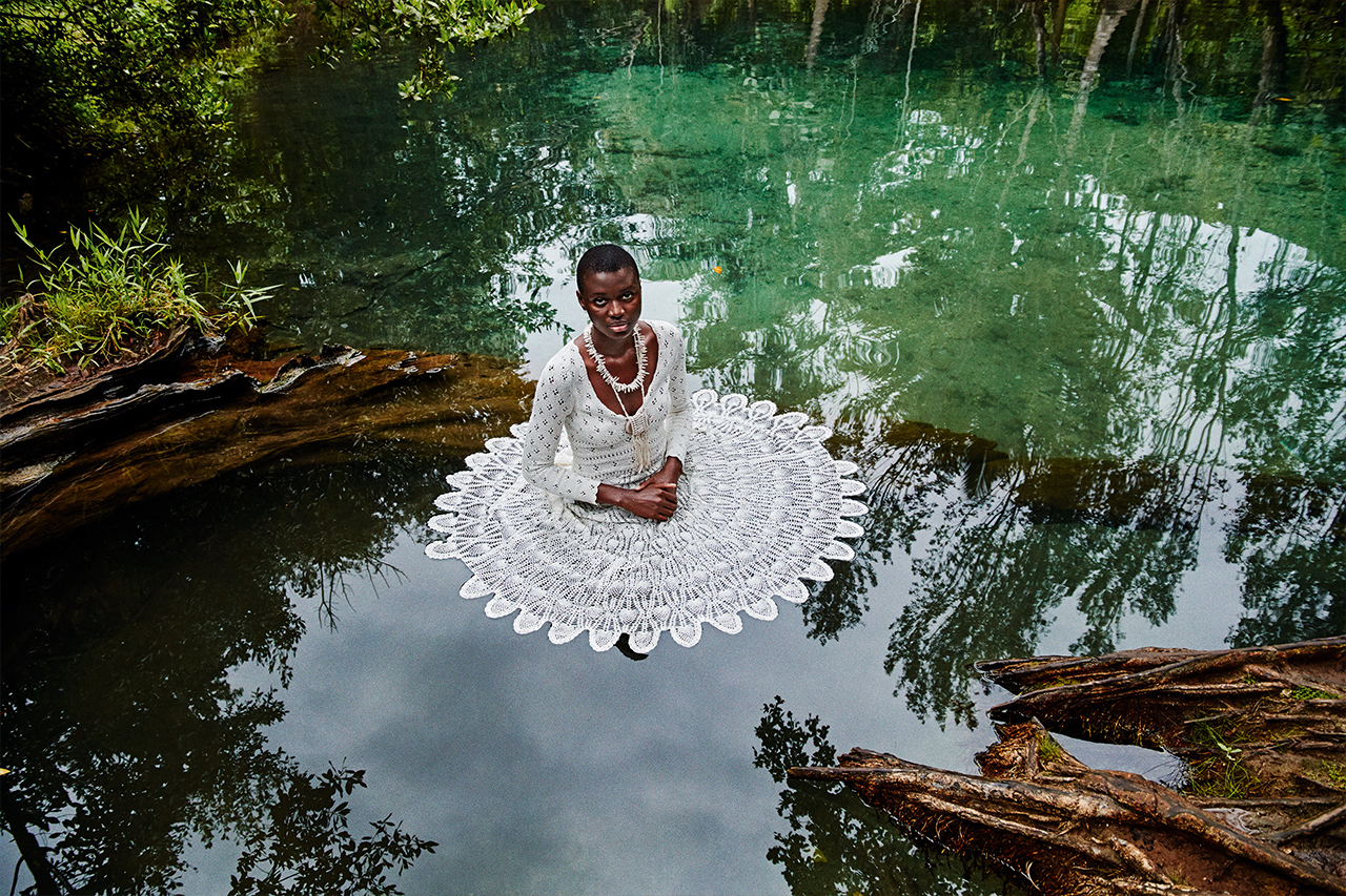 a woman sitting on top of a white doily