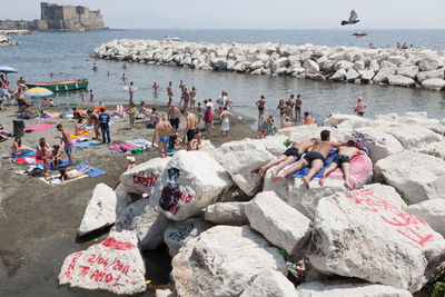 a group of people laying on top of large rocks