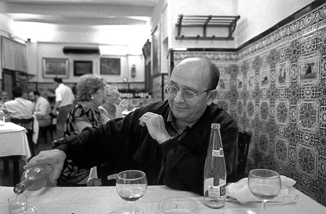 a man sitting at a table in a restaurant