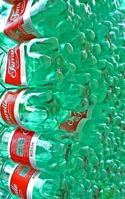 a bunch of soda bottles stacked on top of each other