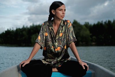 a woman sitting in a boat on a lake