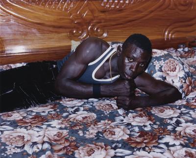 a man laying on top of a bed in a bedroom