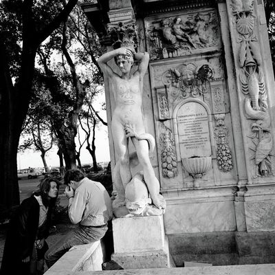 a black and white photo of a statue of a man