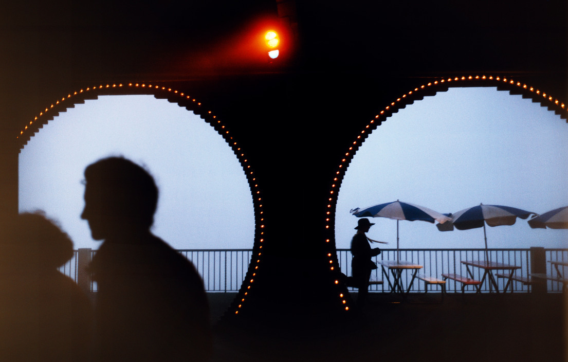 a couple of people standing next to each other under umbrellas