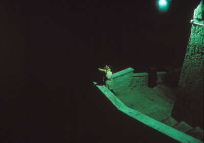 a person standing on a ledge in the dark