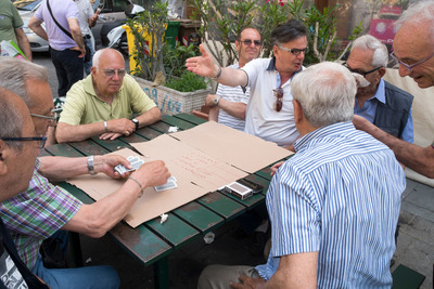 a group of men sitting around a table playing a game