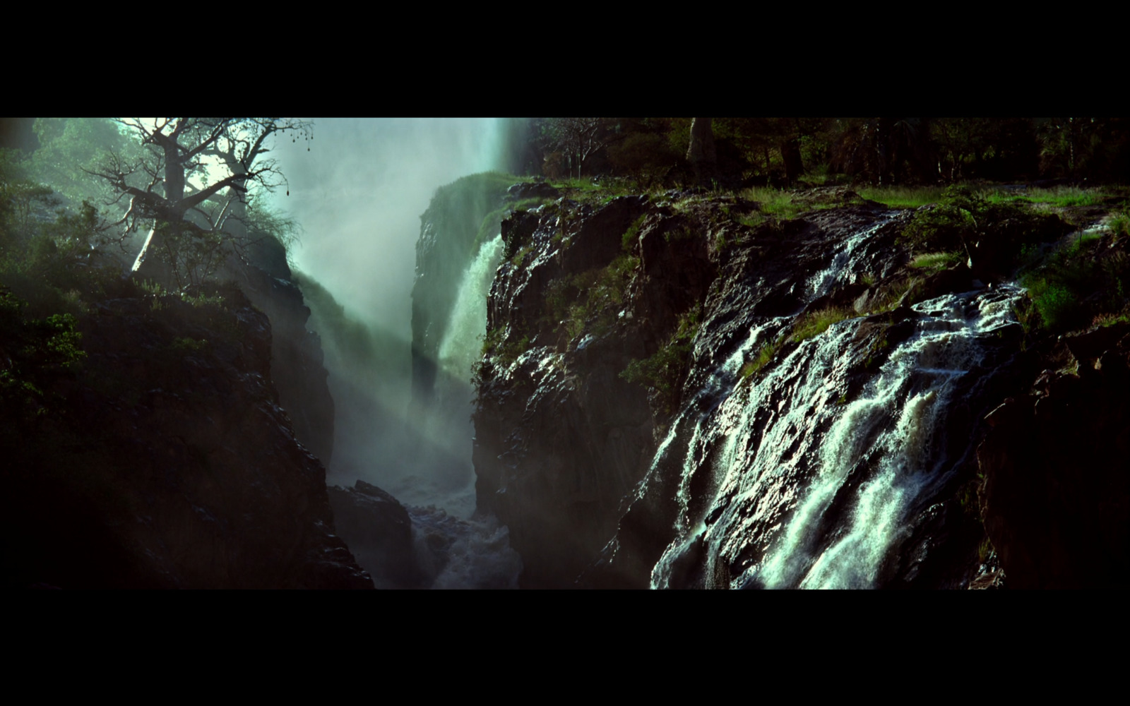 a waterfall in the middle of a forest