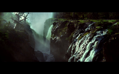 a waterfall in the middle of a forest