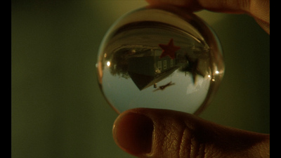 a person holding a glass ball with a house in it