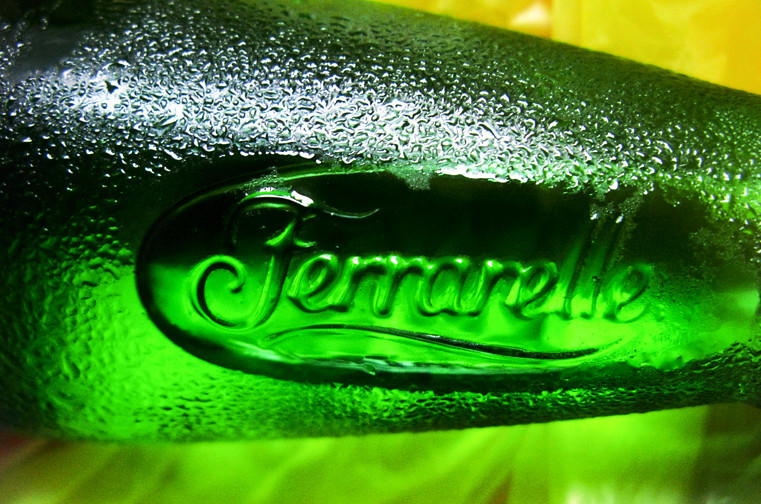 a close up of a green bottle of beer