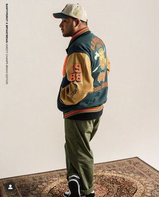 a man standing on a rug wearing a jacket