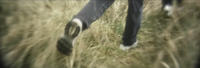 a blurry photo of a person walking through a field