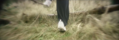 a blurry photo of a person walking through a field