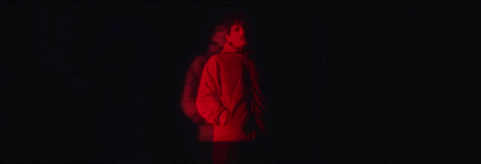 a person standing in the dark with a red light on