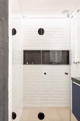 a walk in shower sitting next to a bathroom sink