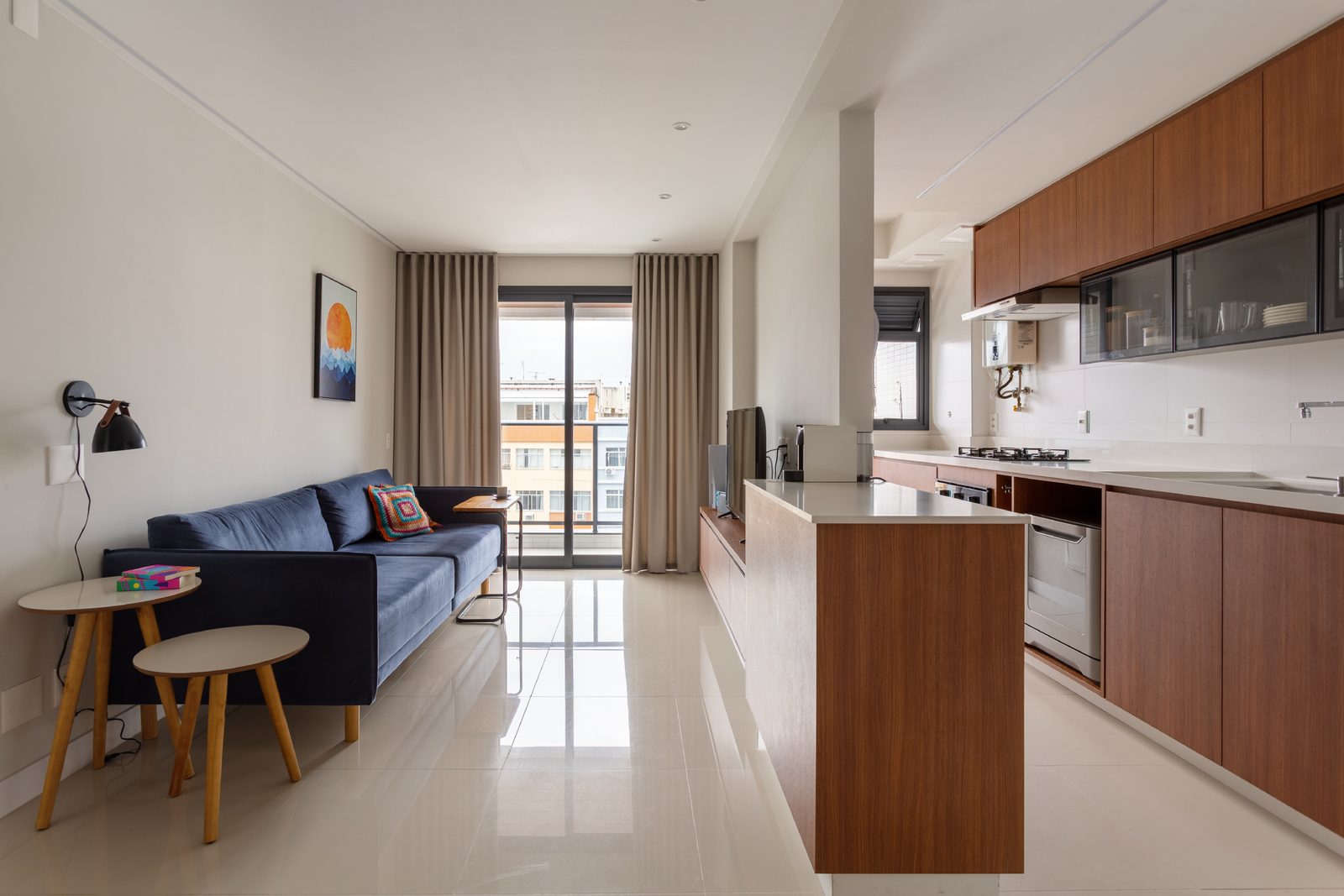 a living room filled with furniture and a kitchen