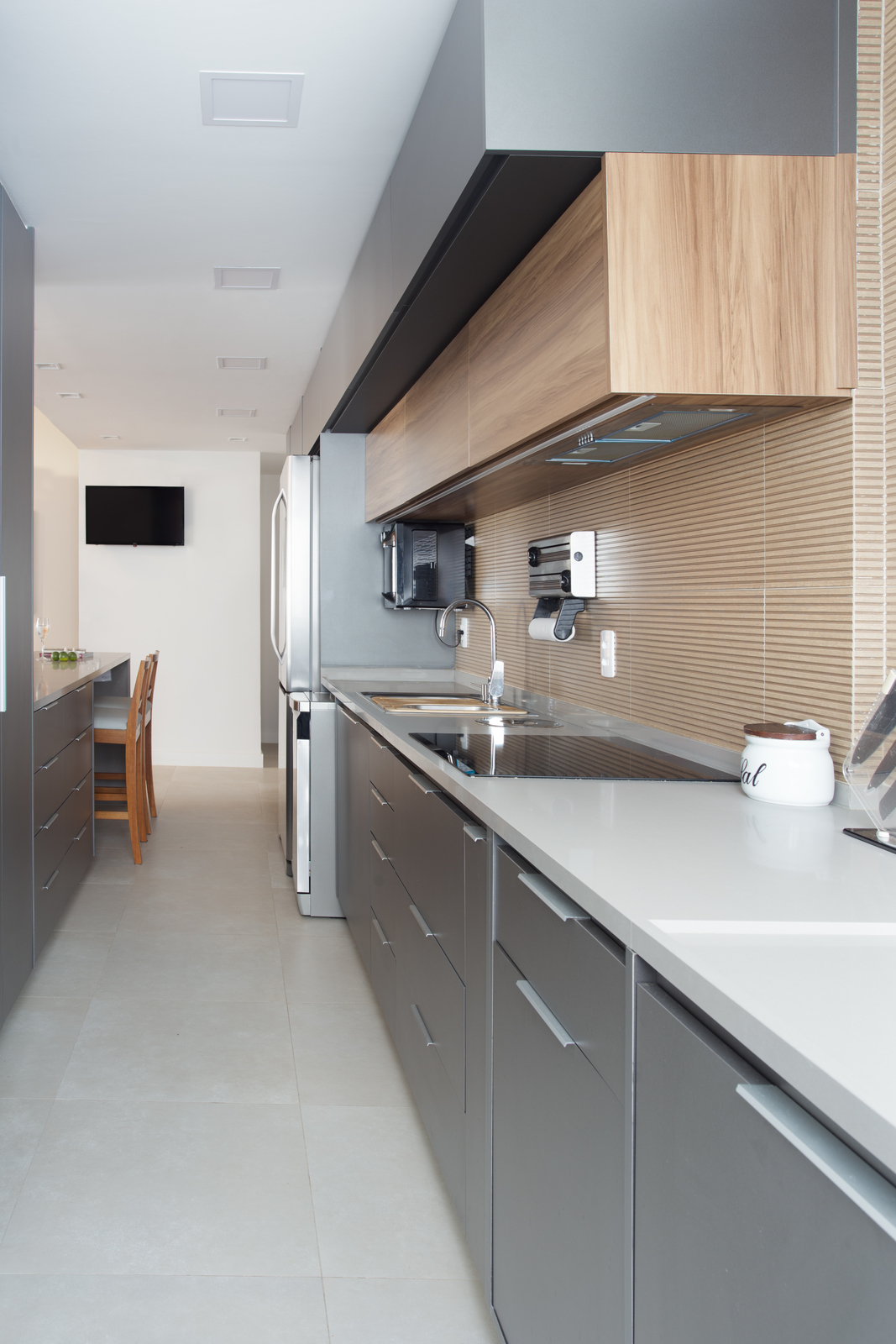 a modern kitchen with stainless steel appliances and wood cabinets