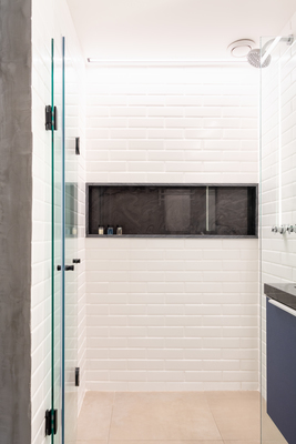 a bathroom with a glass shower door and a sink