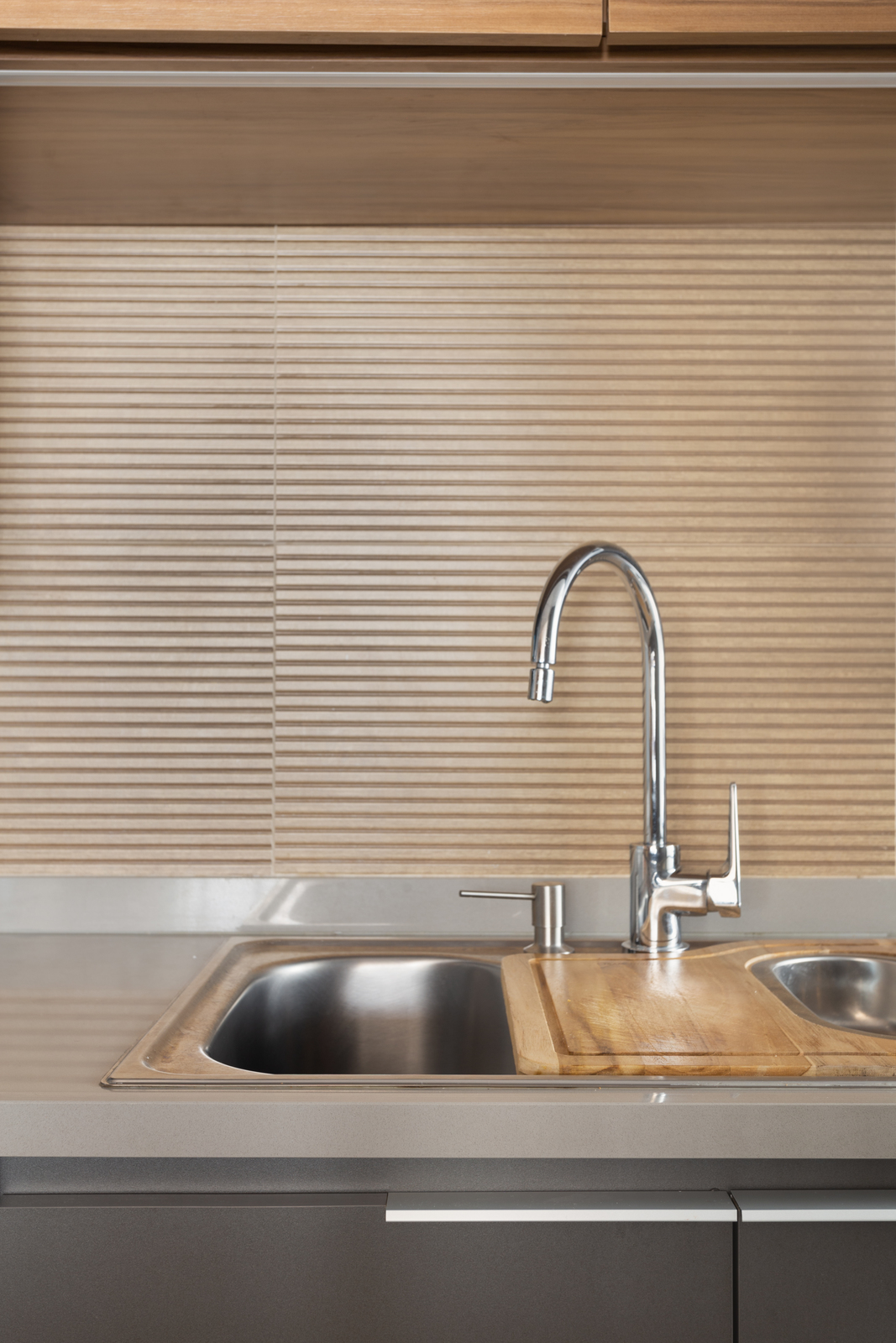 a kitchen sink with a wooden counter top