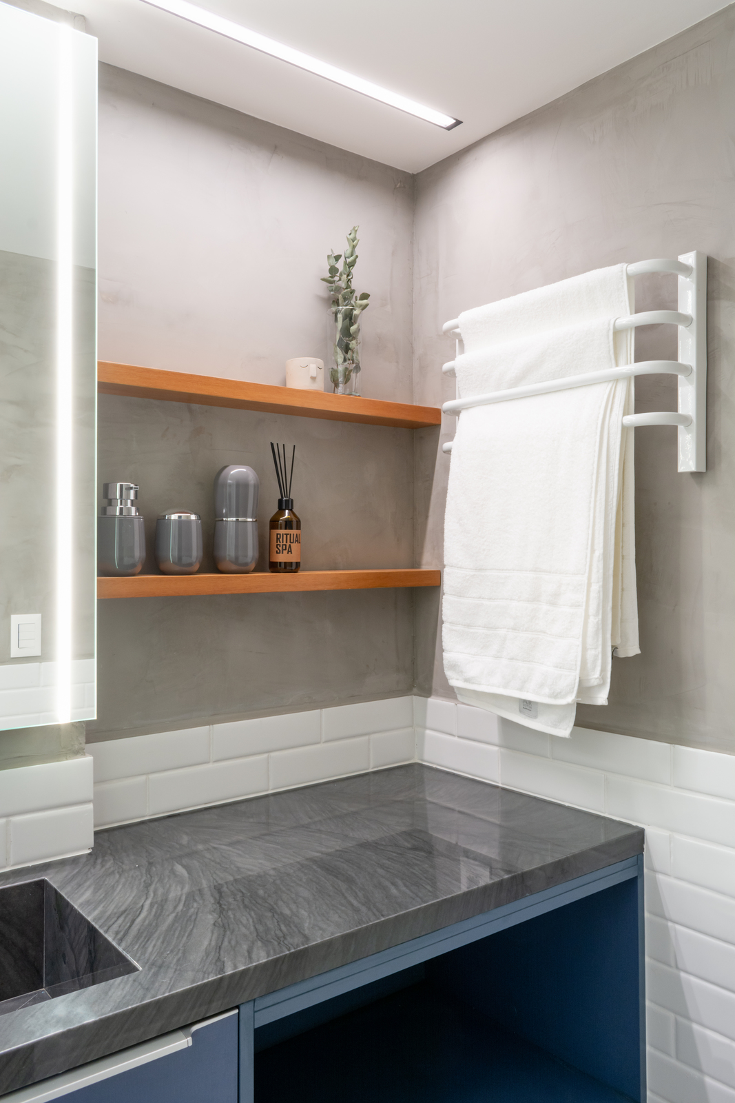 a bathroom with a sink and a towel rack