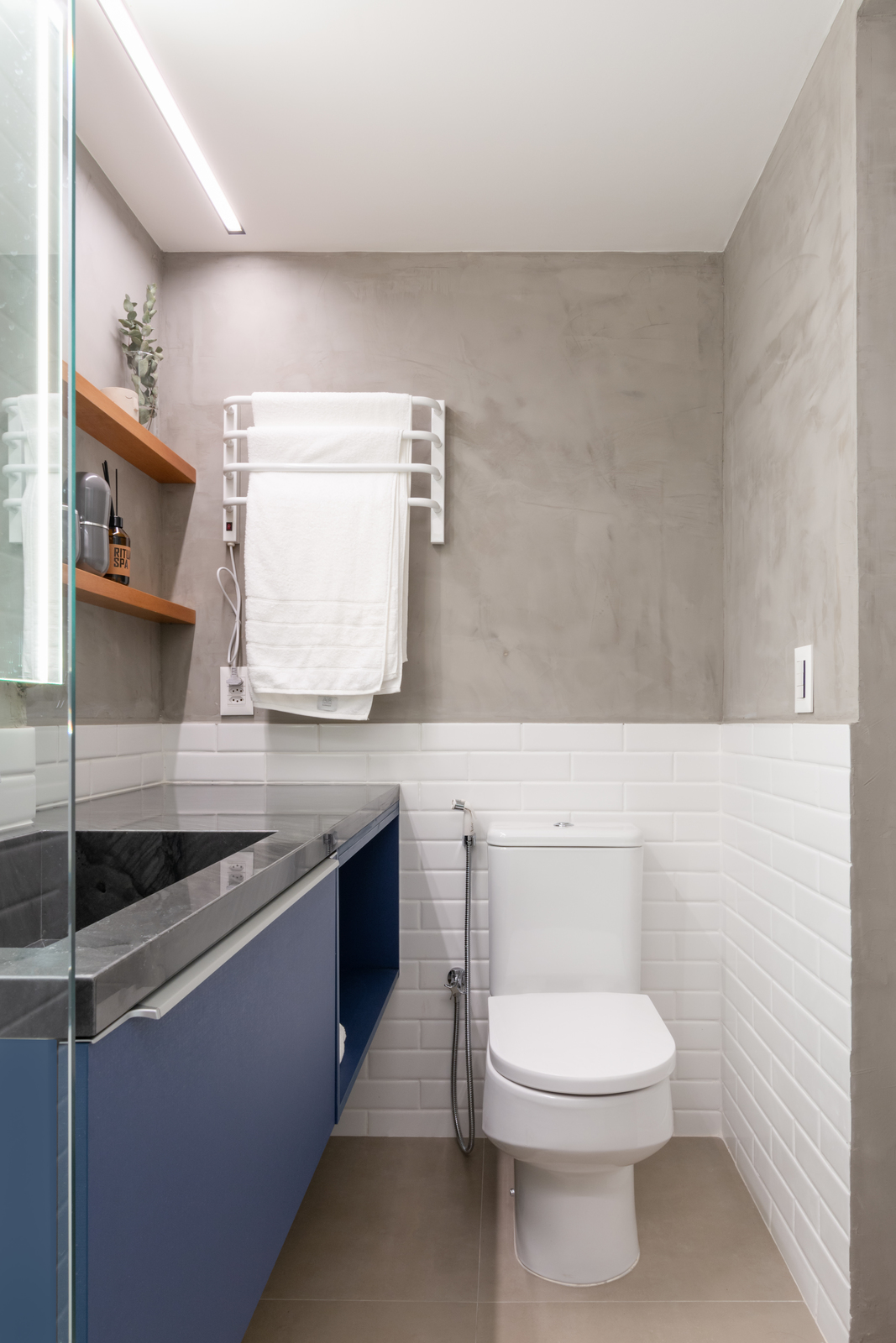 a white toilet sitting next to a bathroom sink