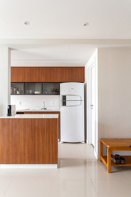 a kitchen with a white refrigerator freezer next to a counter