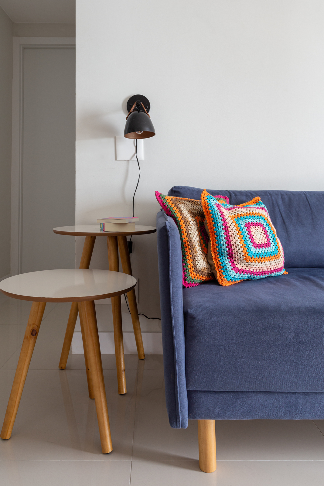 a living room with a blue couch and a table