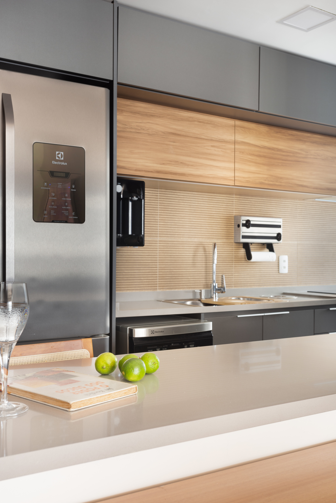 a modern kitchen with stainless steel appliances and a glass of wine