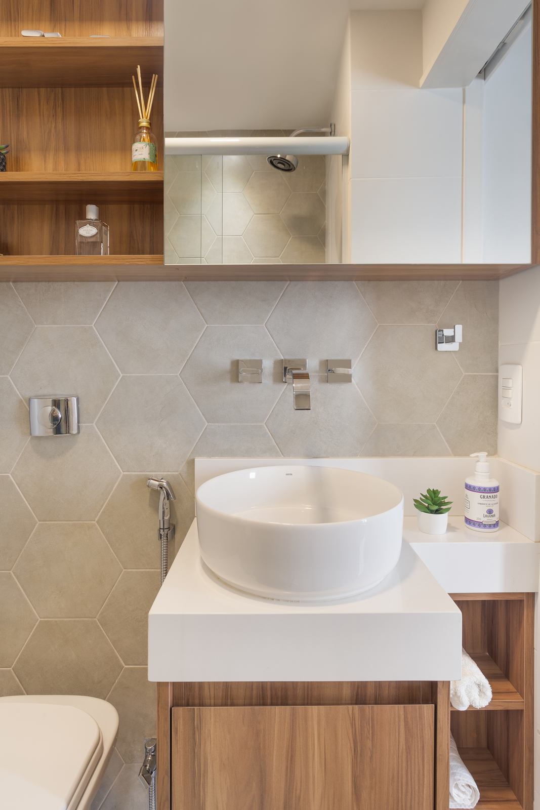 a bathroom with a sink, toilet and shelves