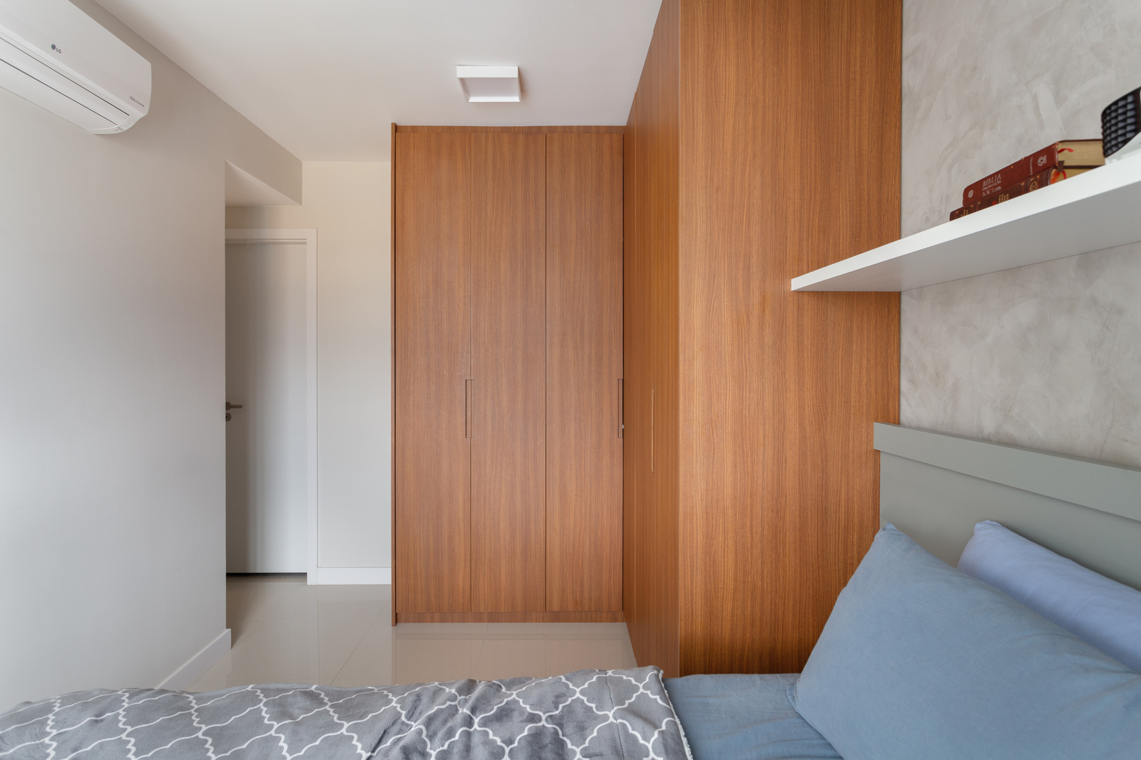 a bed sitting in a bedroom next to a wooden wall