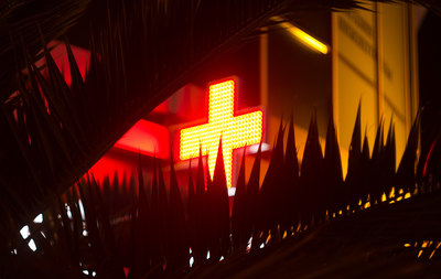 a cross is lit up in the dark