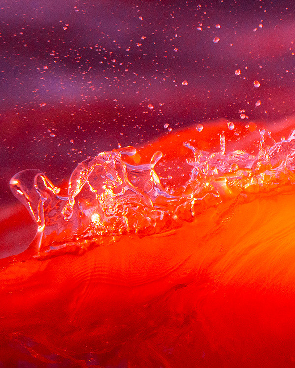 a close up of a red object with water on it