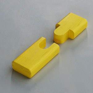 a pair of yellow door handles on a gray surface