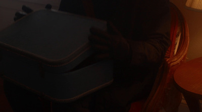 a person holding a suitcase in their hands