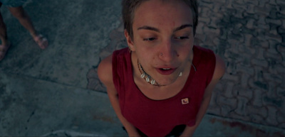 a woman with piercings on her neck looking down