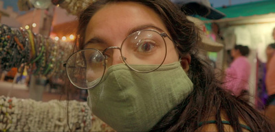 a woman wearing a face mask and glasses